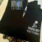 Black zip-up hoodie with 'Radiology Victoria' logo on a white surface, featuring a 'X-Ray' tag.